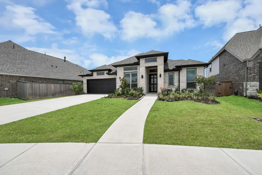 Front exterior of a new home in Valencia, Manvel, TX, highlighting curb appeal (Image 25). Front exterior of a new home in Valencia, Manvel, TX, highlighting curb appeal (Image 25).