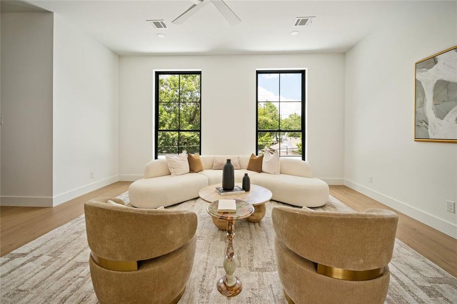 Living area featuring a ceiling fan and wood finished floors