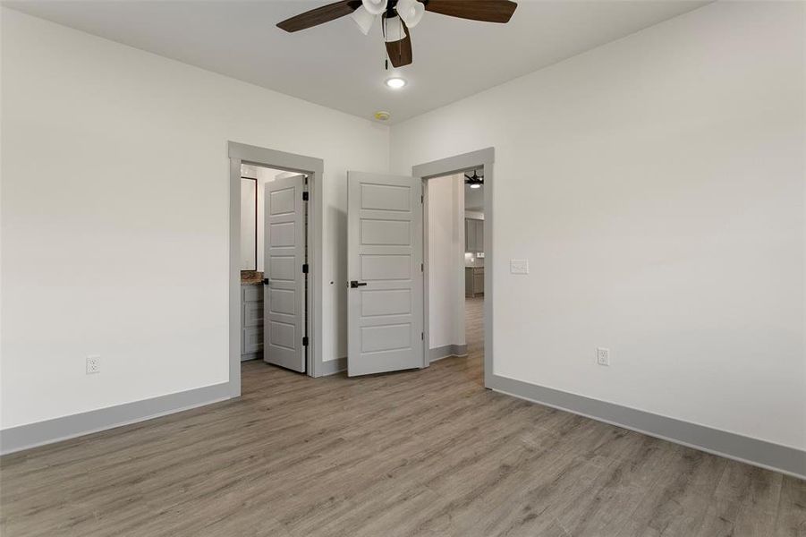 Unfurnished bedroom featuring ceiling fan and light hardwood / wood-style flooring