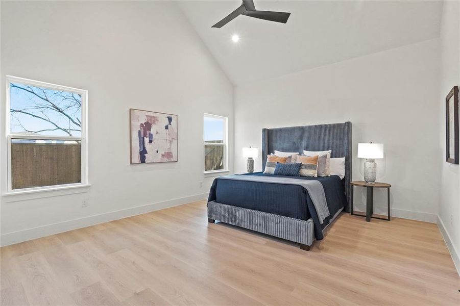 Bedroom with light wood-style floors, vaulted ceiling, a ceiling fan, and recessed lighting