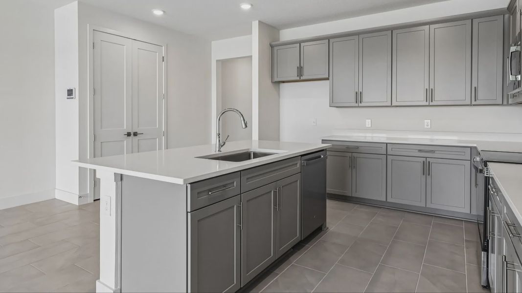 Longleaf Floor Plan Kitchen and Stunning Island by DRB Homes Lakeside at Satilla in New Homes St. Cloud