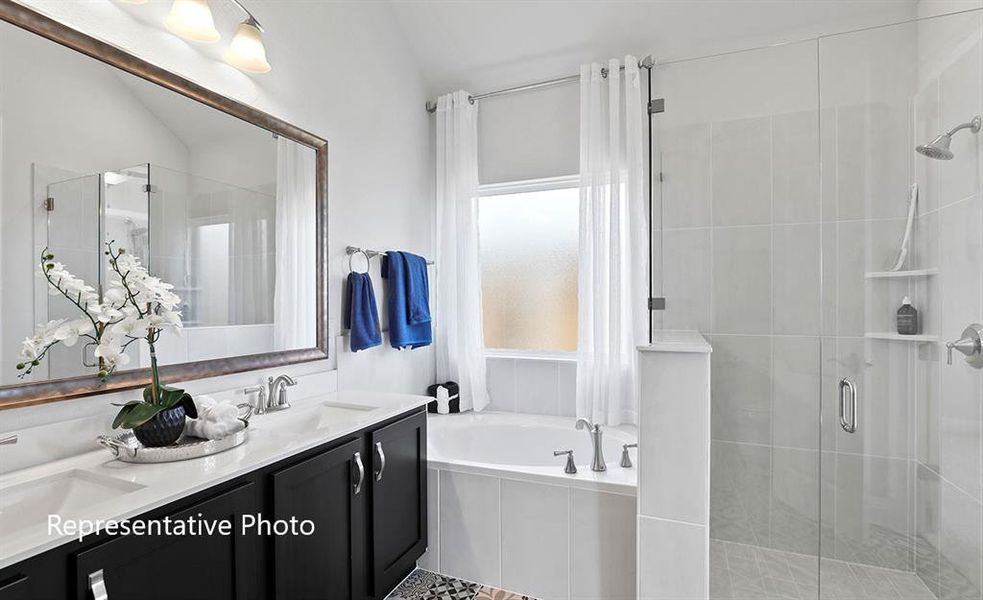 Bathroom featuring a dual vanity with dark cabinetry, white countertops, and chrome fixtures
