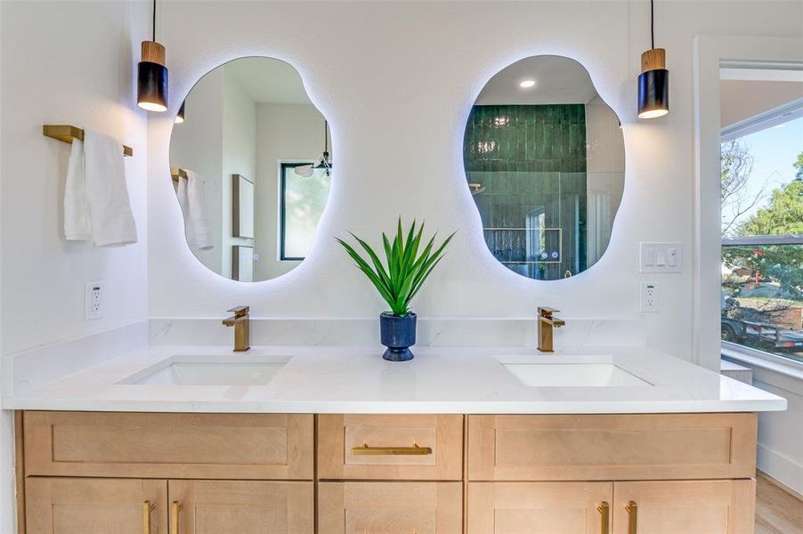 Full bath featuring double vanity and a shower Full bath featuring double vanity and a shower