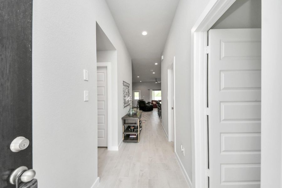 Stepping across the threshold reveals a crisp, sunlit entryway that hints at the fluid layout beyond.