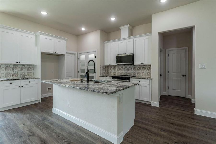 Kitchen pantry has double frosted class doors.