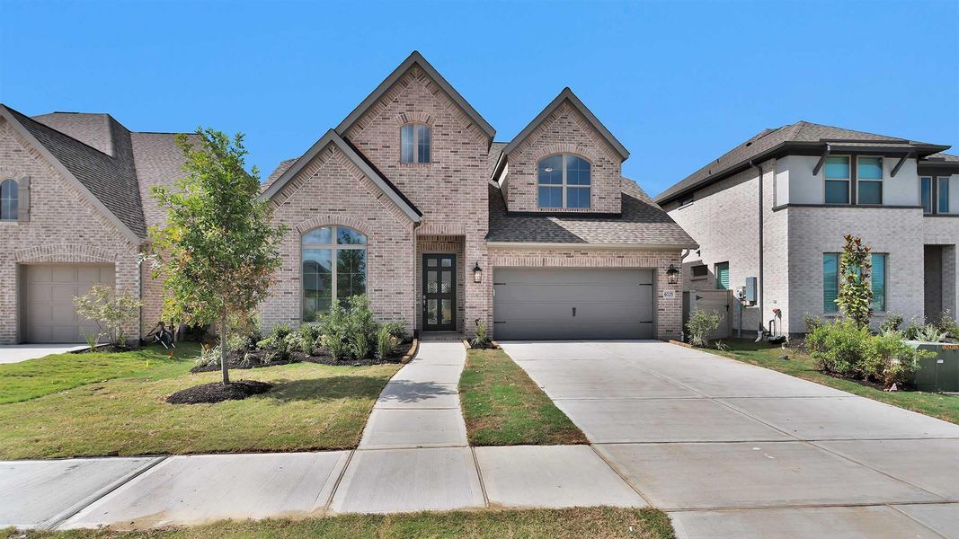 Front exterior of a new home in Legacy, League City, TX, highlighting curb appeal (Image 2). Front exterior of a new home in Legacy, League City, TX, highlighting curb appeal (Image 2).