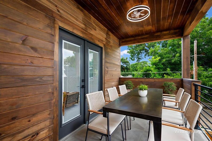 Balcony featuring outdoor dining area and french doors
