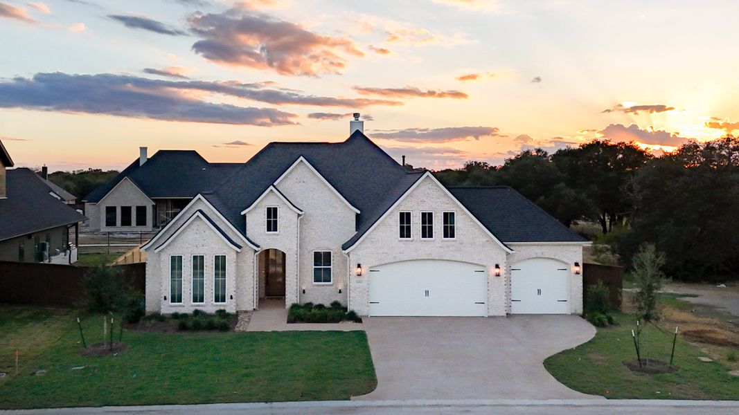 Front exterior of a new home in Greens Prairie Reserve, College Station, TX, highlighting curb appeal (Image 1). Front exterior of a new home in Greens Prairie Reserve, College Station, TX, highlighting curb appeal (Image 1).