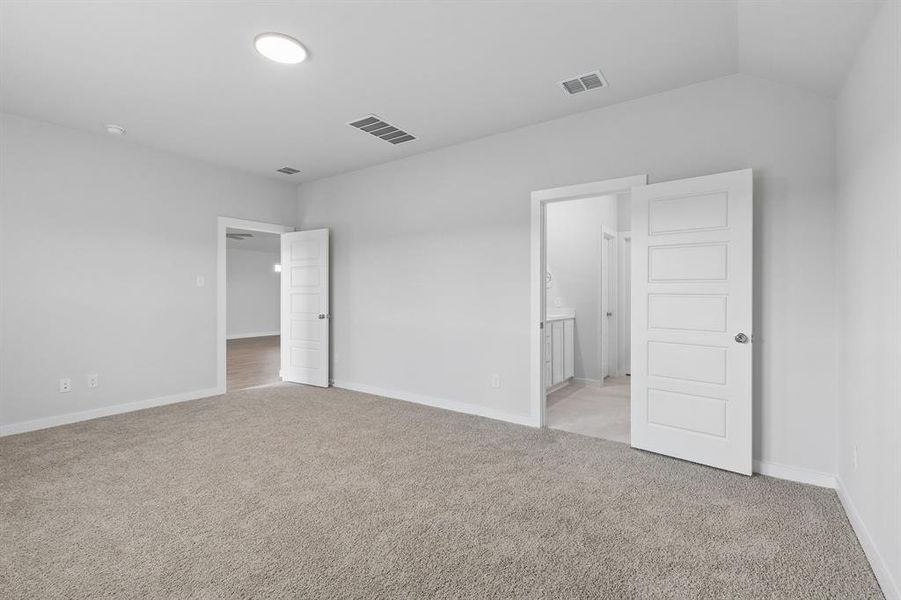 Primary Suite in the Oscar home plan by Trophy Signature Homes – REPRESENTATIVE PHOTO