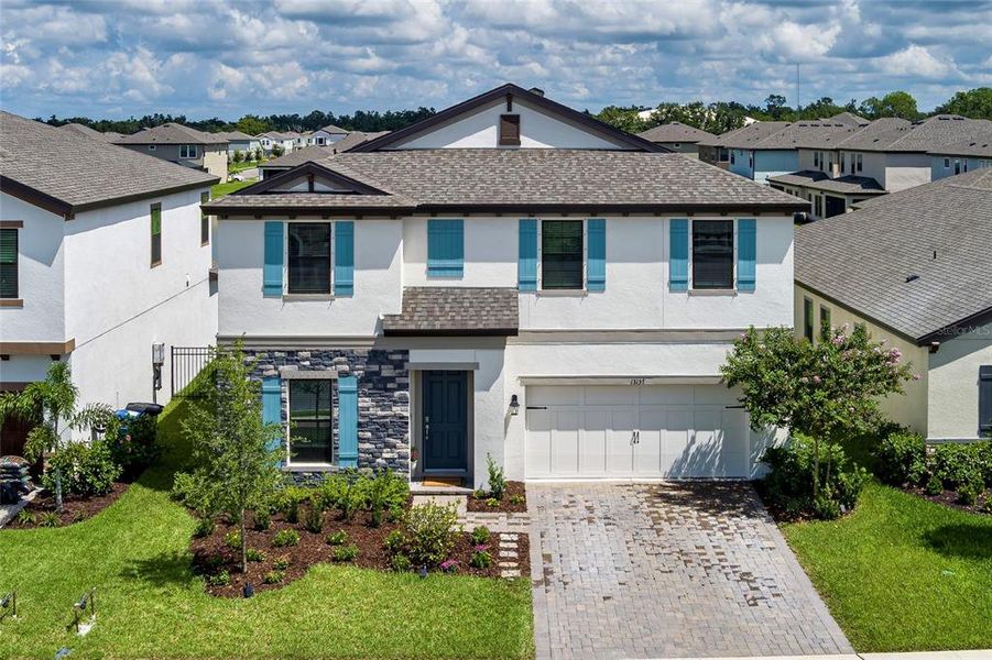 Front exterior of a new home in Crosswind Point, Parrish, FL, highlighting curb appeal (Image 24).