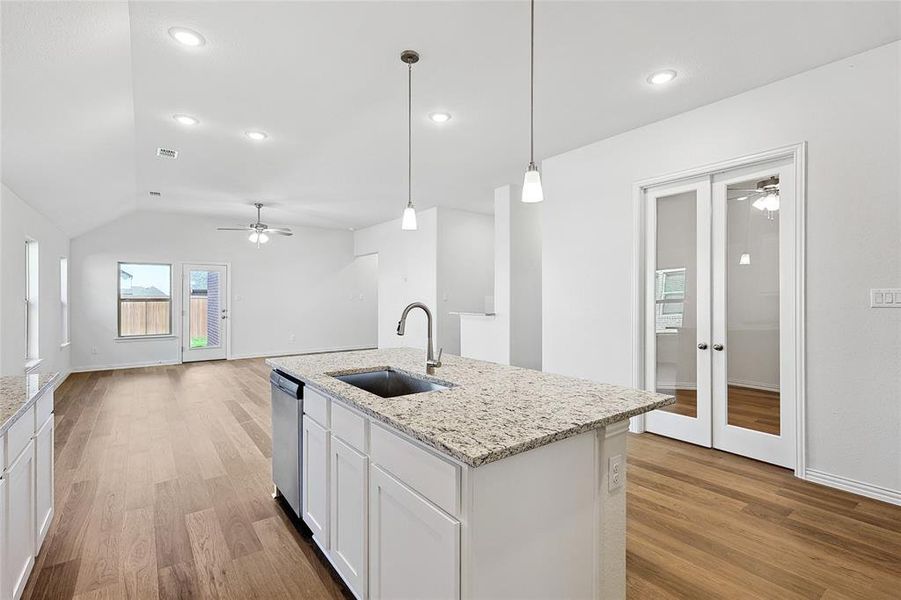 Kitchen featuring ceiling fan, light hardwood / wood-style flooring, sink, and white cabinetry