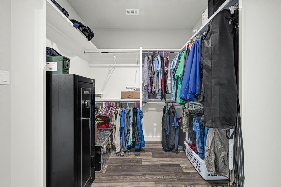 Large primary closet with access to laundry room, and doubles as a safe room