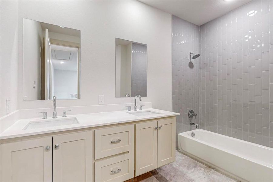 Bathroom featuring vanity and tiled shower / bath combo