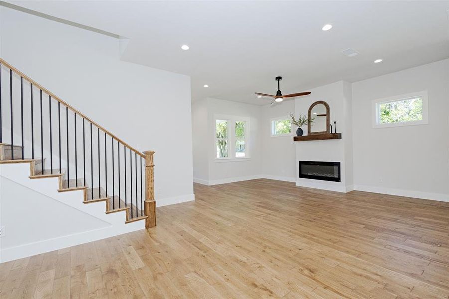 Soft, Neutral French Oak Solid Hardwood Floors and a sleek Electric Heat-Producing Fireplace create a warm, inviting living space. Soft, Neutral French Oak Solid Hardwood Floors and a sleek Electric Heat-Producing Fireplace create a warm, inviting living space.