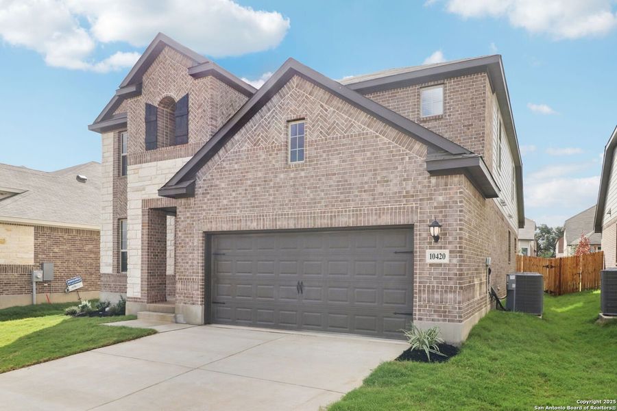 Front exterior of a new home in Fox Falls, Boerne, TX, highlighting curb appeal (Image 1). Front exterior of a new home in Fox Falls, Boerne, TX, highlighting curb appeal (Image 1).