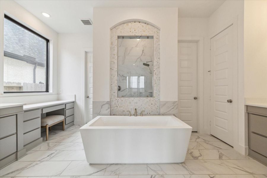 Soaking in this tub at the end of the day will be so relaxing. One side of the bathroom even has a make up area with penty of drawers and window to let in lots of natural light when getting ready. Soaking in this tub at the end of the day will be so relaxing. One side of the bathroom even has a make up area with penty of drawers and window to let in lots of natural light when getting ready.