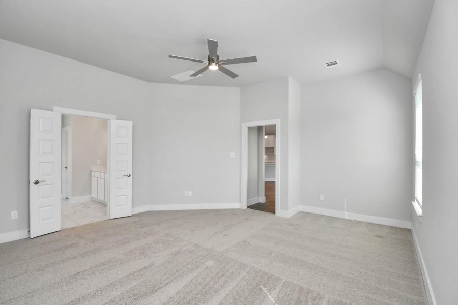 Escape to tranquility in this spacious primary room, adorned with plush carpeting and bathed in the soothing hues of warm paint colors, creating a cozy retreat for relaxation. Escape to tranquility in this spacious primary room, adorned with plush carpeting and bathed in the soothing hues of warm paint colors, creating a cozy retreat for relaxation.