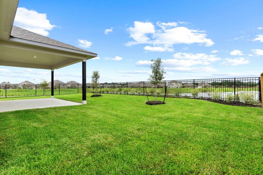 Enjoy outdoor living with this extended covered patio and fully fenced backyard—complete with open green space and tranquil lake views just beyond. What a perfect place to call home! Enjoy outdoor living with this extended covered patio and fully fenced backyard—complete with open green space and tranquil lake views just beyond. What a perfect place to call home!