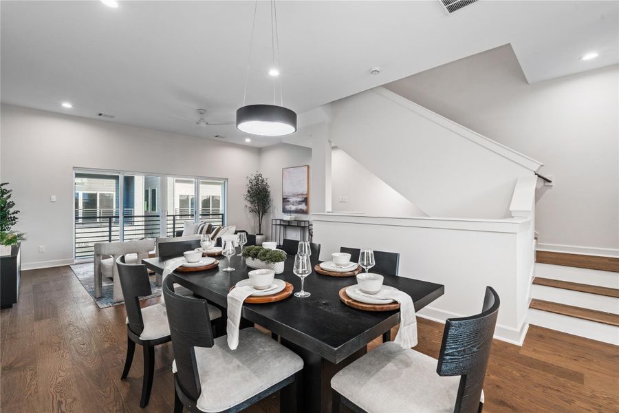 With ample room for a dining table of any size, this area feels open and functional. Its position next to the staircase also provides a smooth transition to the third floor, keeping everything connected.