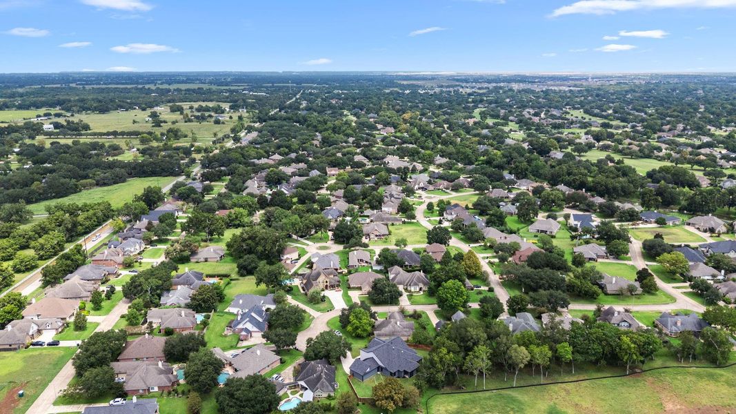 This aerial photo showcases a spacious suburban neighborhood with well-maintained homes, abundant greenery, and ample yard space, offering a serene and family-friendly environment. This aerial photo showcases a spacious suburban neighborhood with well-maintained homes, abundant greenery, and ample yard space, offering a serene and family-friendly environment.