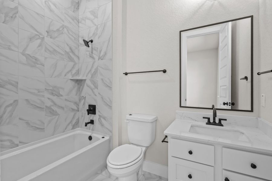 A bathroom with a tub toilet and sink. A bathroom with a tub toilet and sink.