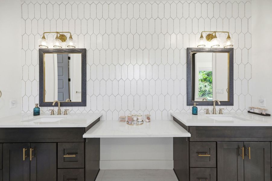 Geometric tile and clean stone counters define this modern double vanity space.