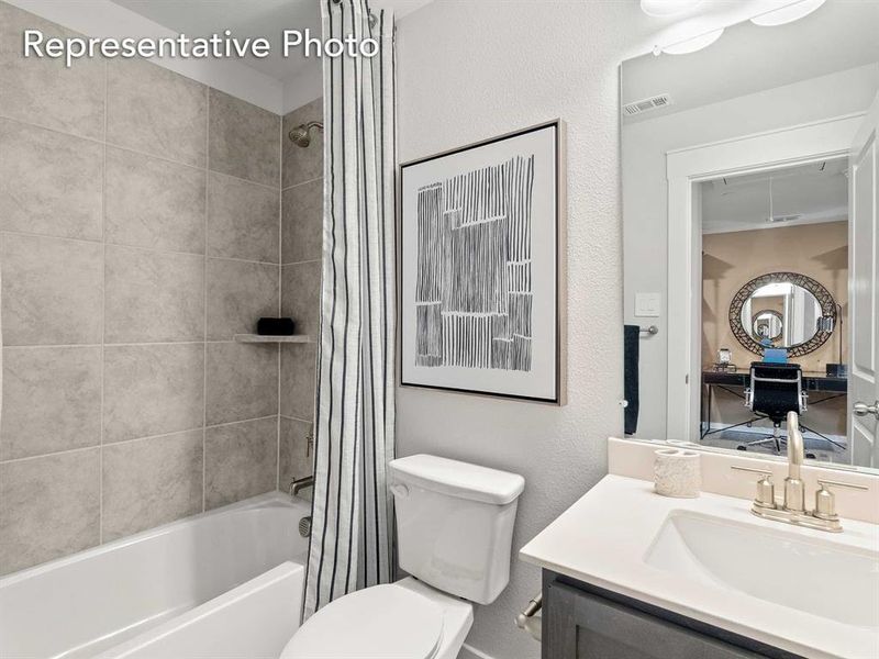 Full bathroom featuring vanity, toilet, and shower / bath combo with shower curtain