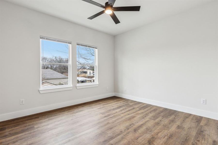 Unfurnished room with ceiling fan and hardwood / wood-style flooring