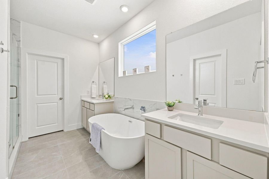 Dual vanities provide individual counter and storage space, complemented by quartz countertops, oversized mirrors and a freestanding soaking tub. Dual vanities provide individual counter and storage space, complemented by quartz countertops, oversized mirrors and a freestanding soaking tub.