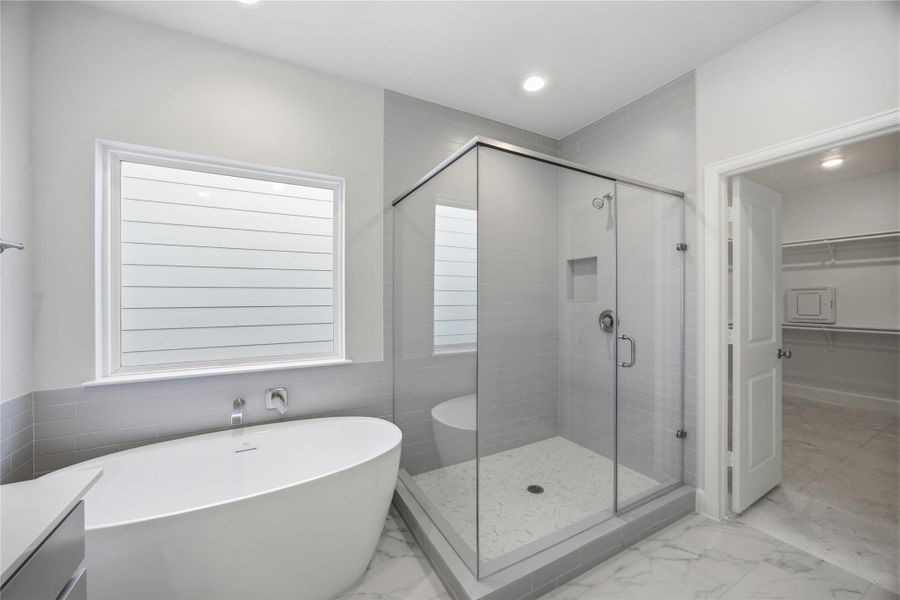 Freestanding Soaking Tub – The centerpiece of the primary bathroom, this freestanding soaking tub invites you to unwind in a spa-like setting with its sleek design and tranquil ambiance. Experience luxury in the glass-enclosed walk-in shower, featuring elegant tile and premium fixtures for a serene start or end to your day.