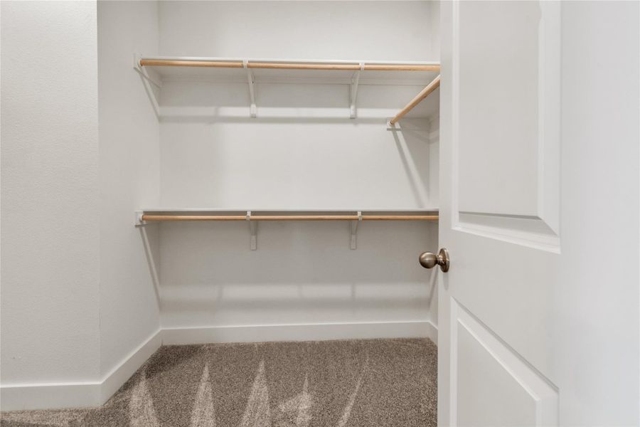 Ample hanging space and shelving create a versatile storage solution.