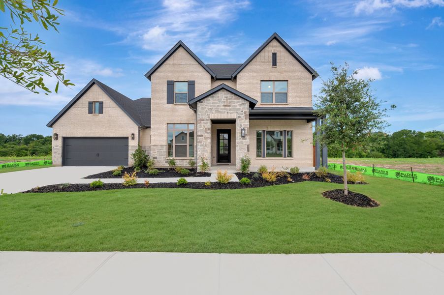Front exterior of a new home in Monterra - Classics, Fate, TX, highlighting curb appeal (Image 1). Front exterior of a new home in Monterra - Classics, Fate, TX, highlighting curb appeal (Image 1).