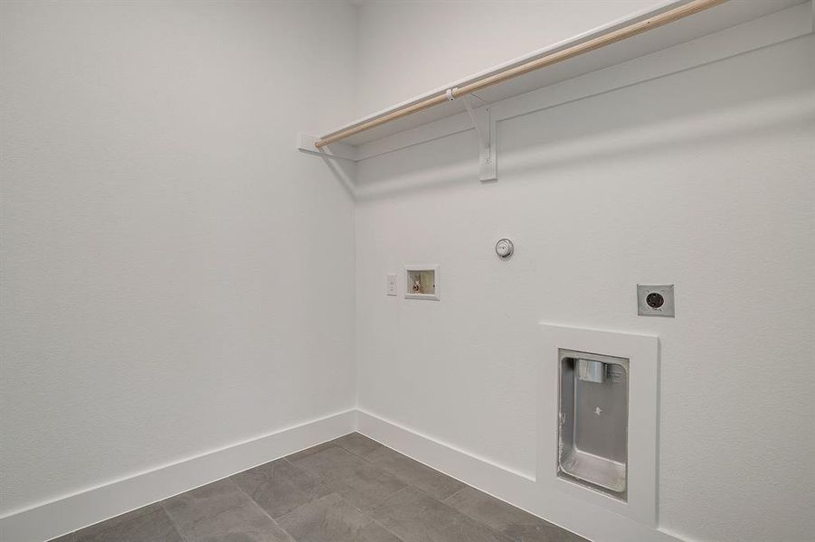 Laundry area featuring hookup for a gas dryer, electric dryer hookup, and washer hookup Laundry area featuring hookup for a gas dryer, electric dryer hookup, and washer hookup