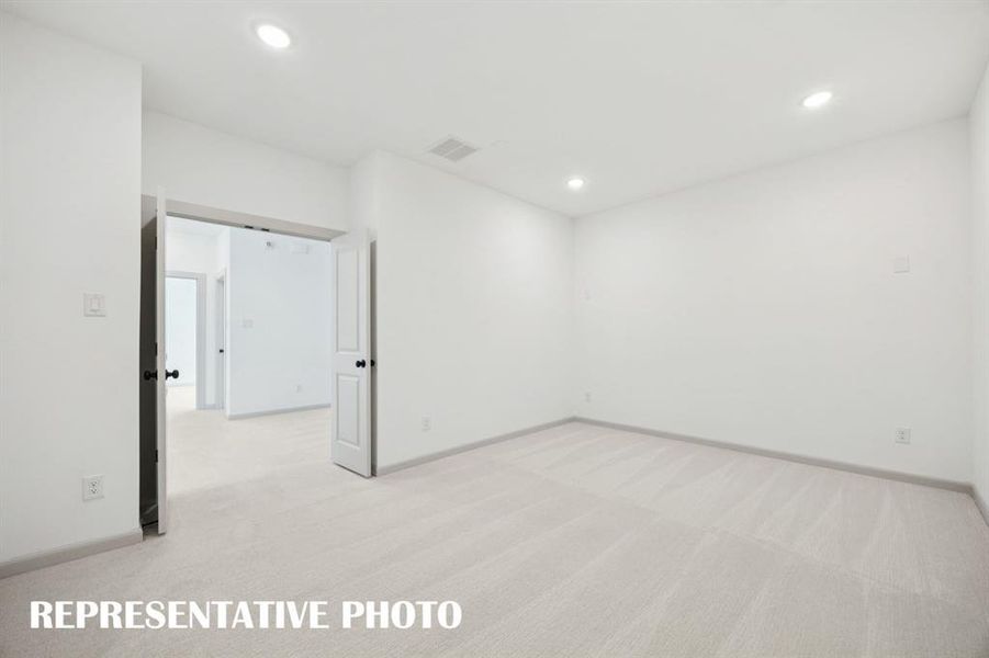 This spacious media room with adjacent game room creates the ultimate family entertainment zone!  REPRESENTATIVE PHOTO