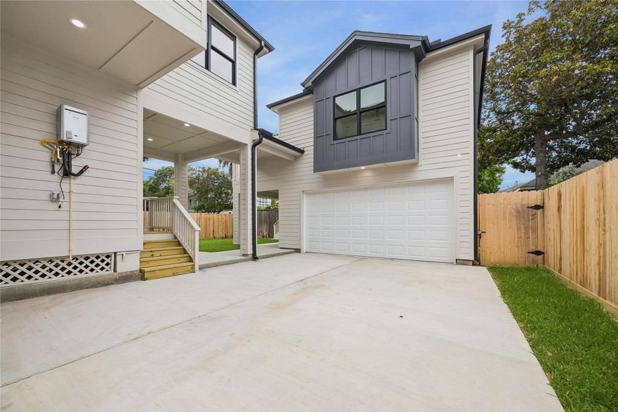 The rear exterior showcases the home’s expansive outdoor layout including elevated terraces, covered entertaining areas, and a fully fenced backyard. Multiple outdoor living spaces create flexibility for entertaining, relaxing, or future backyard enhancements while maintaining privacy within the property.