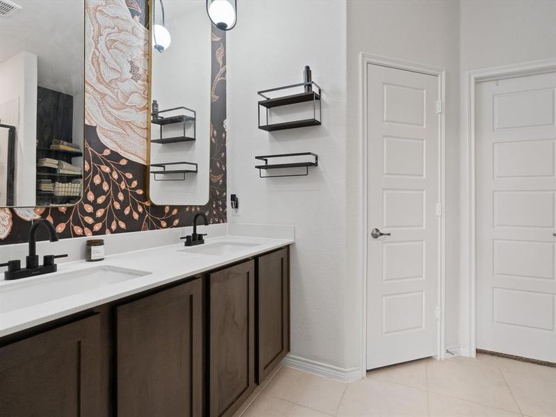 Bathroom featuring tile patterned flooring and vanity