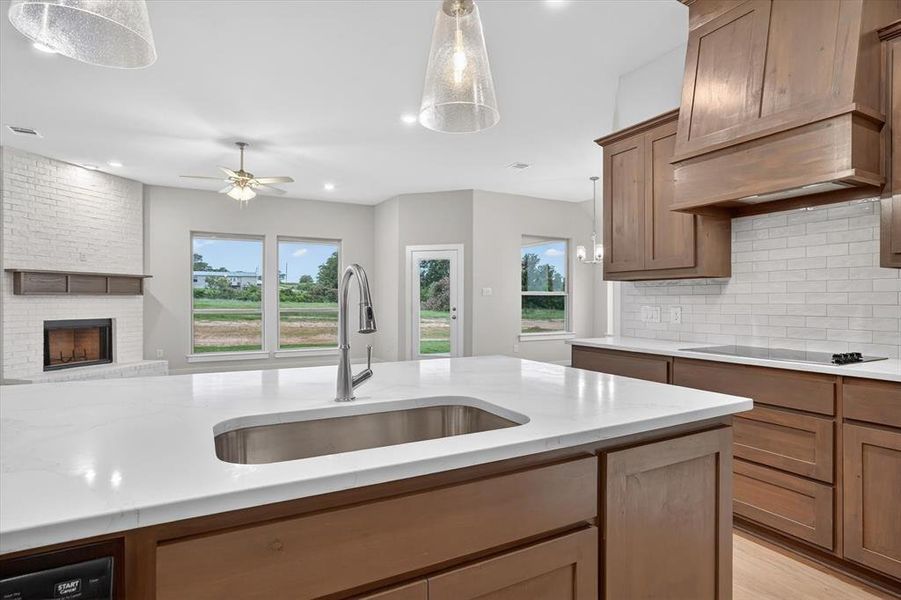 Central kitchen island with an undermount sink and white solid surface countertop