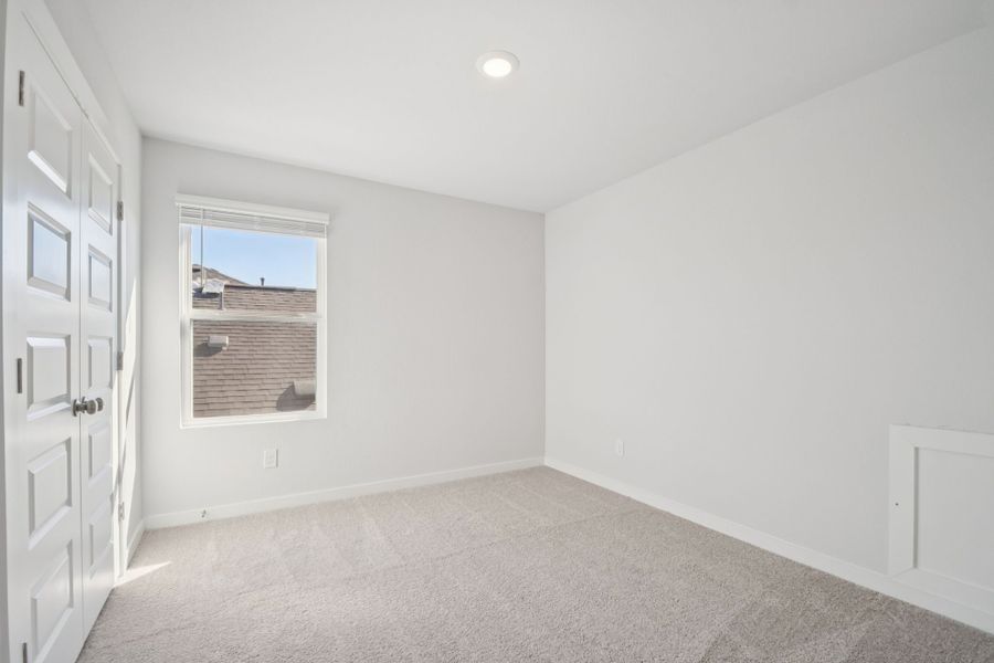 A room with white walls and a window.