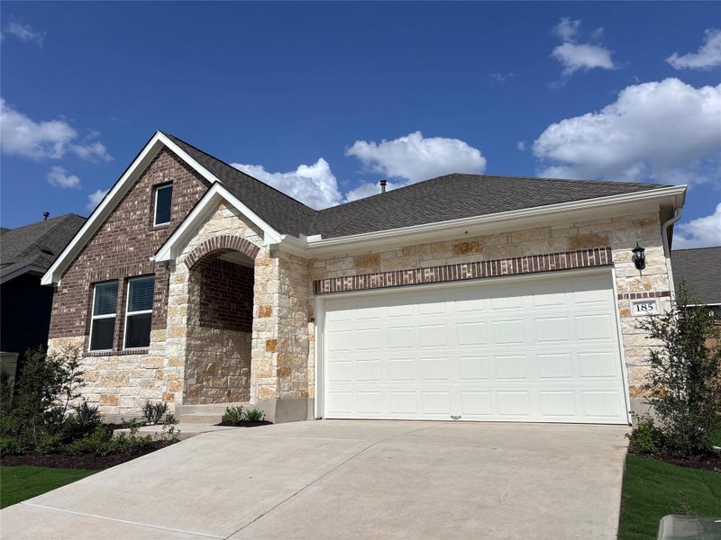 Front exterior of a new home in The Colony 50s, Cedar Creek, TX, highlighting curb appeal (Image 13). Front exterior of a new home in The Colony 50s, Cedar Creek, TX, highlighting curb appeal (Image 13).