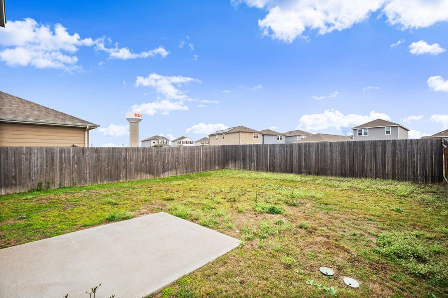 Fenced backyard with a patio and a residential view
