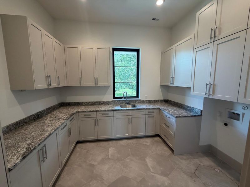 August 11 view of progress in the utility room of your dreams. A single unit washer/dryer will be installed. Imagine loading your close into one machine setting it to wash then dry and coming back to a finished load of laundry. Incredible storage and ample counter space for folding and organizing your clothing.