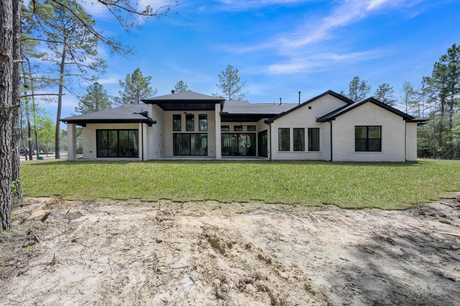Seamless indoor-outdoor living extends to a covered patio, perfect for relaxing, dining, or entertaining while enjoying peaceful views of the property.