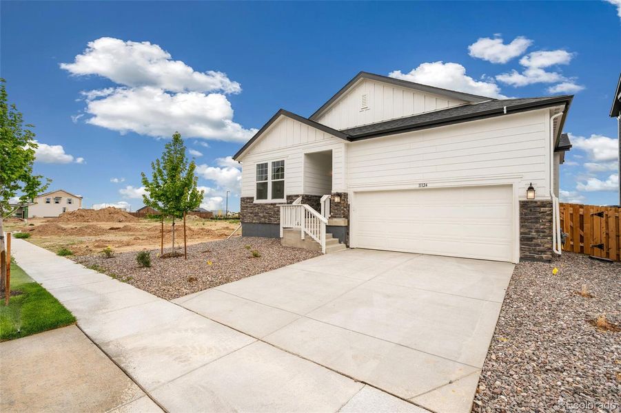 Front exterior of a new home in Turnberry, Commerce City, CO, highlighting curb appeal (Image 18).