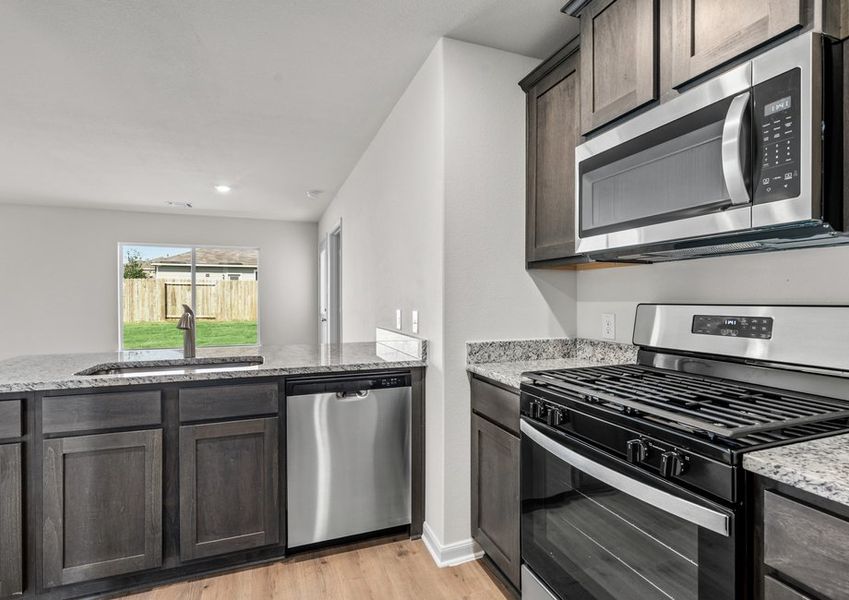 The kitchen looks out into the dining room.
