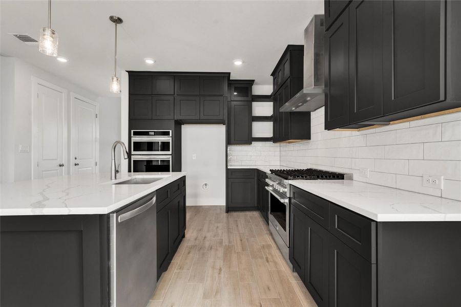 Modern dark cabinetry and crisp countertops define this well-appointed culinary space.