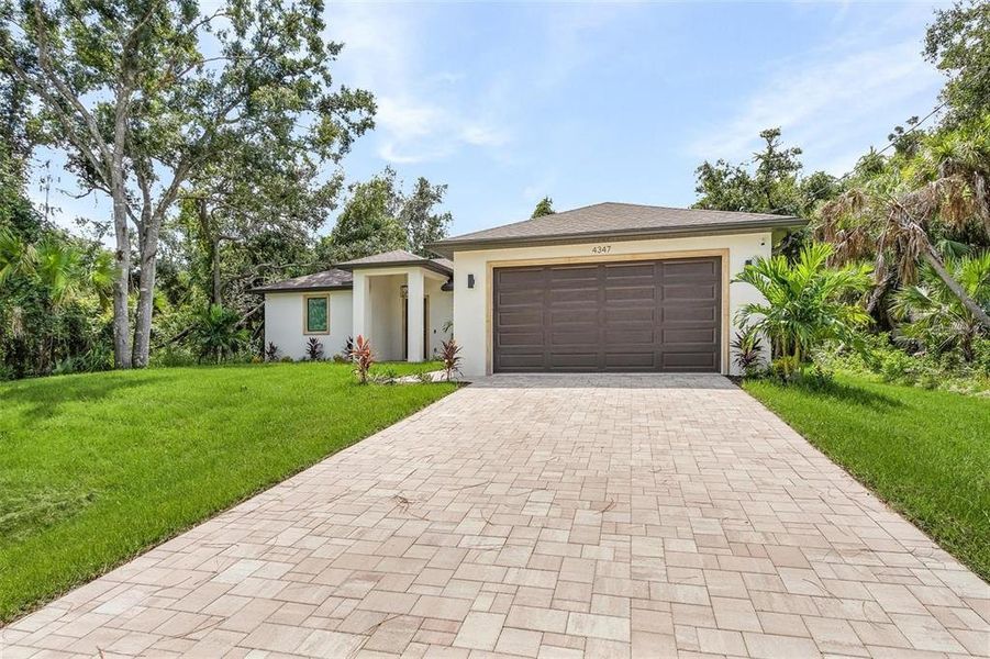 Front exterior of a new home in , North Port, FL, highlighting curb appeal (Image 2). Front exterior of a new home in , North Port, FL, highlighting curb appeal (Image 2).