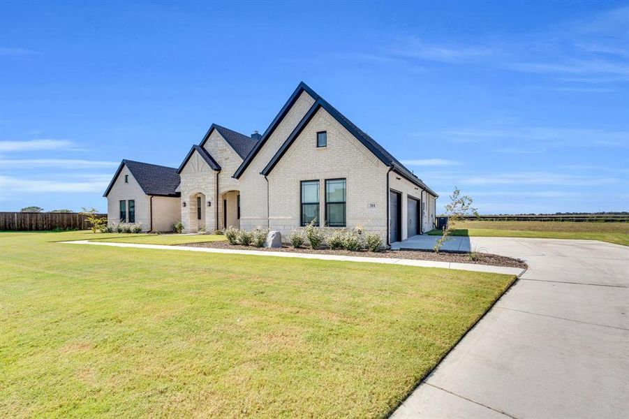 Front exterior of a new home in Springside Estates II, Waxahachie, TX, highlighting curb appeal (Image 18).