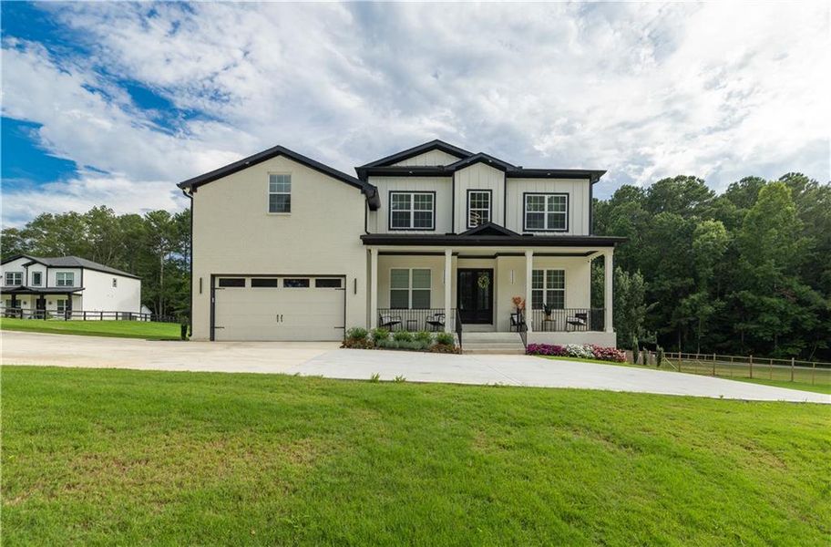 Front exterior of a new home in , Snellville, GA, highlighting curb appeal (Image 25). Front exterior of a new home in , Snellville, GA, highlighting curb appeal (Image 25).