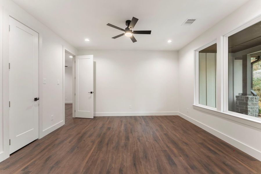 This study has a closet and is right next to a full bath so this could easily be a 6th bedroom. The neutral walls and recessed lighting create a modern and airy feel.
