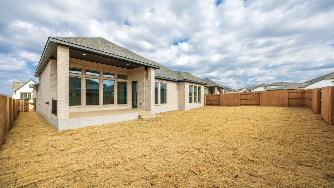 Exterior details and patio area of a home in The Colony, Bastrop (Image 2).